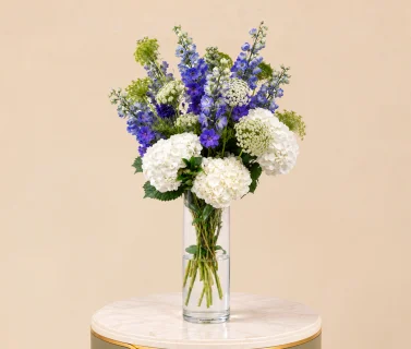 White Hydrangea & Blue Delphinium in Clear Glass Vase 1
